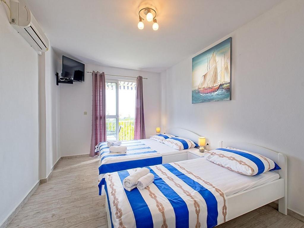 Posteľ alebo postele v izbe v ubytovaní Apartments Grljević