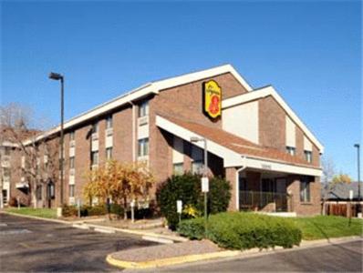 a large brick building with a fast food restaurant at Super 8 by Wyndham Westminster Denver North in Westminster