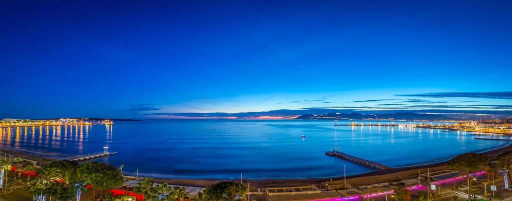- une vue sur une grande étendue d'eau la nuit dans l'établissement STUDIO PALM BEACH CANNES, à Cannes