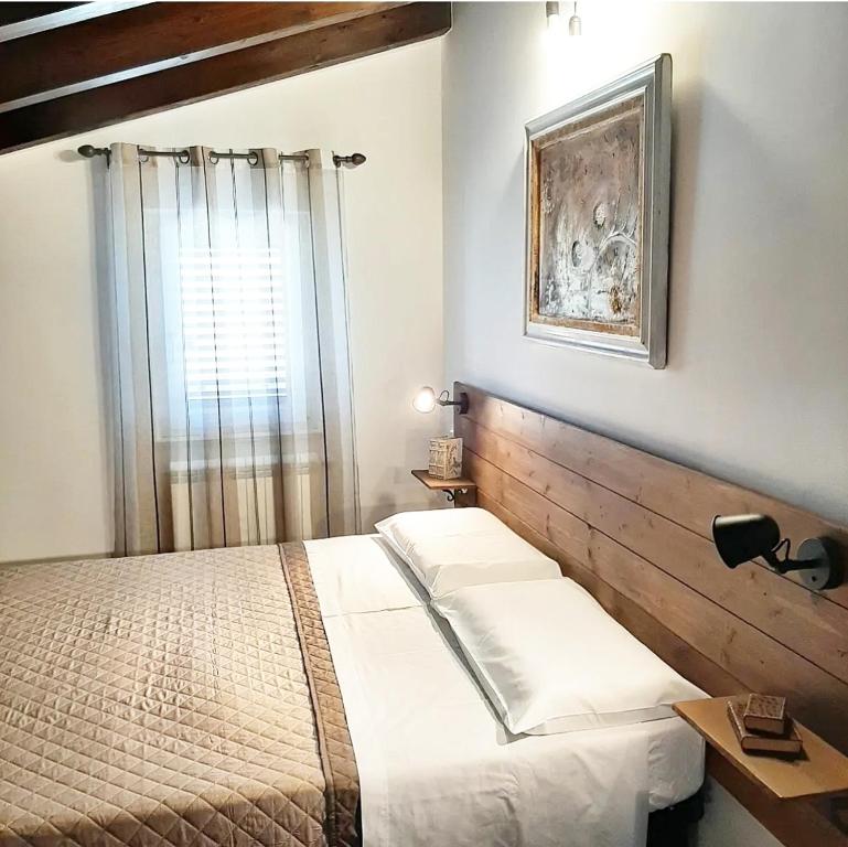 a bedroom with a bed and a window at Stè Sweet home M&A in Scanzano