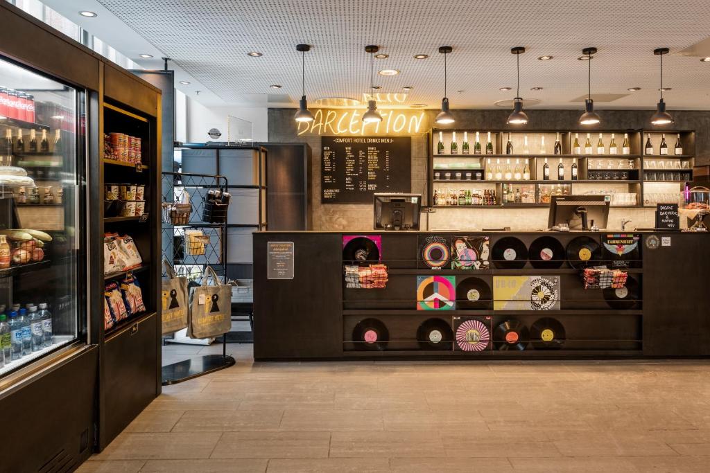 a store with a bakery with a counter with food at Comfort Hotel Trondheim in Trondheim