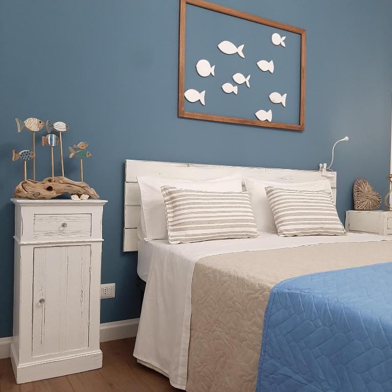a bedroom with a bed and a blue wall at Stè Sweet home M&A in Scanzano