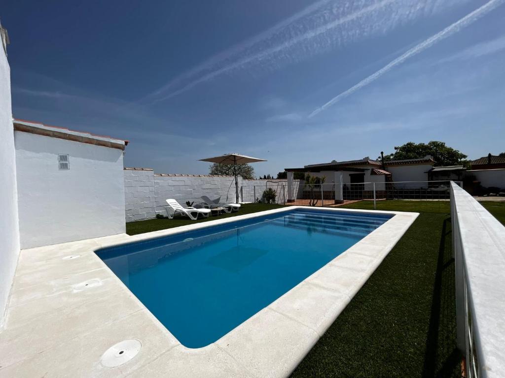 a swimming pool in the backyard of a house at Casa rural El Limonero in Campano
