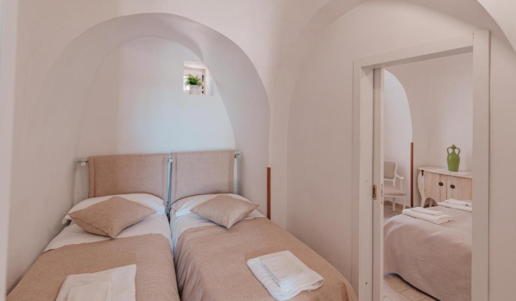 Posteľ alebo postele v izbe v ubytovaní Trulli Dal Conte