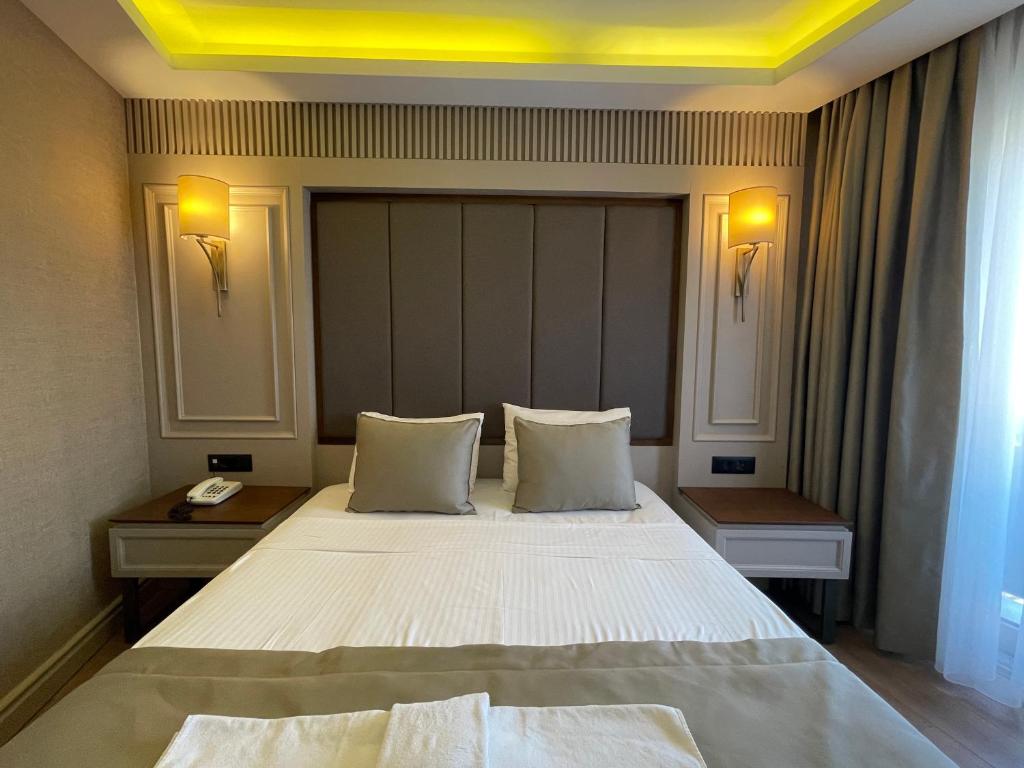 Postel nebo postele na pokoji v ubytování Martinenz Hotel