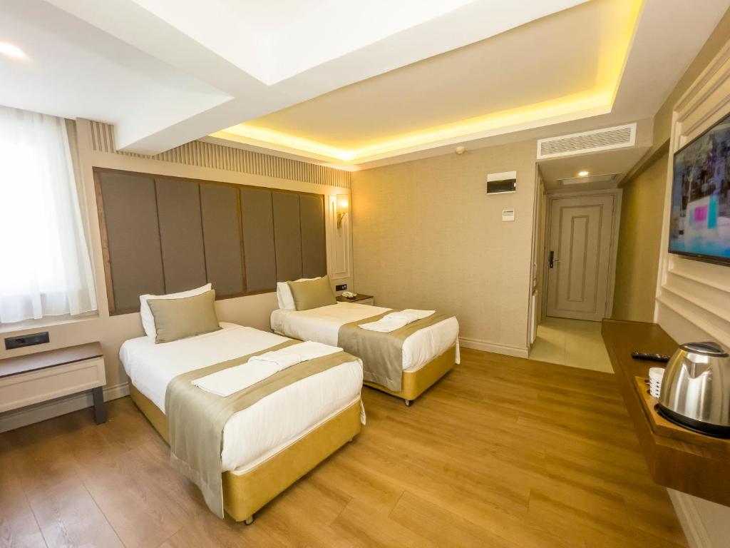 Postel nebo postele na pokoji v ubytování Martinenz Hotel