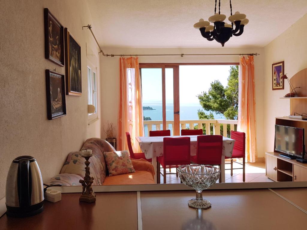 a living room with a view of a table and chairs at Villa Brela in Brela