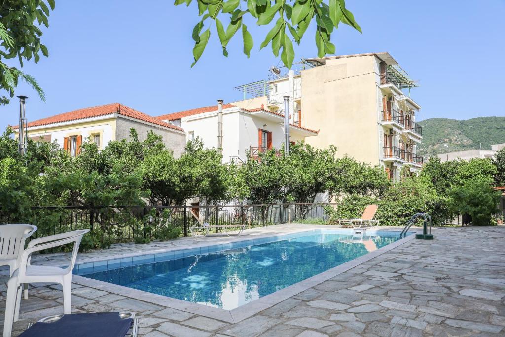 a swimming pool in front of a building at Hotel Aggeliki in Skopelos Town