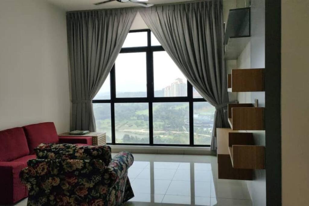 a living room with a couch and a large window at Conezion 3-bedroom condo @ IOI City Mall Putrajaya in Serdang