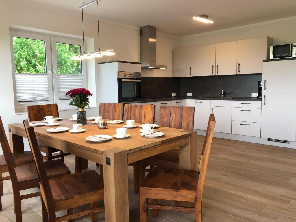 a kitchen and dining room with a wooden table and chairs at Ferienhof-Micheel-Haeuser-bis-7-Personen in Gammendorf