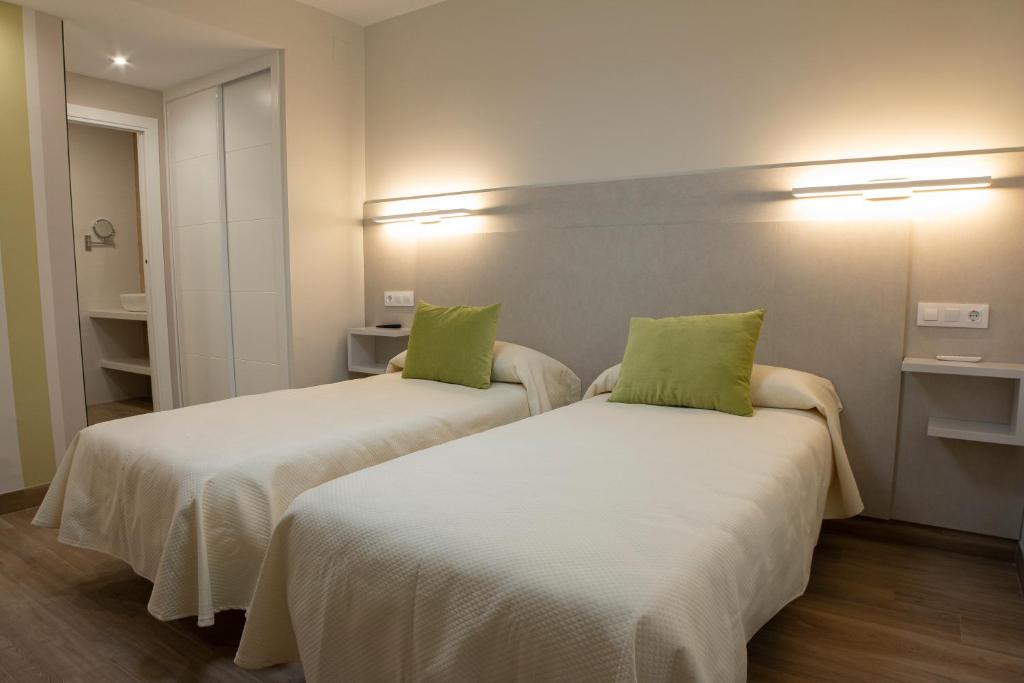 Postel nebo postele na pokoji v ubytování Hostal Restaurante el Cary