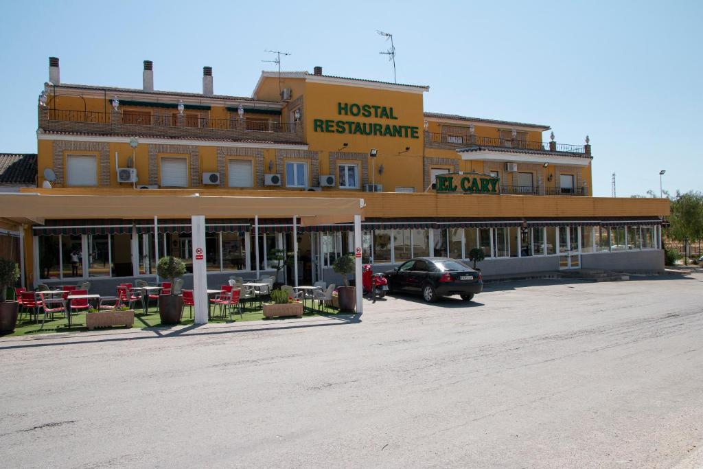 a hotel with a car parked in a parking lot at Hostal Restaurante el Cary in Montemayor