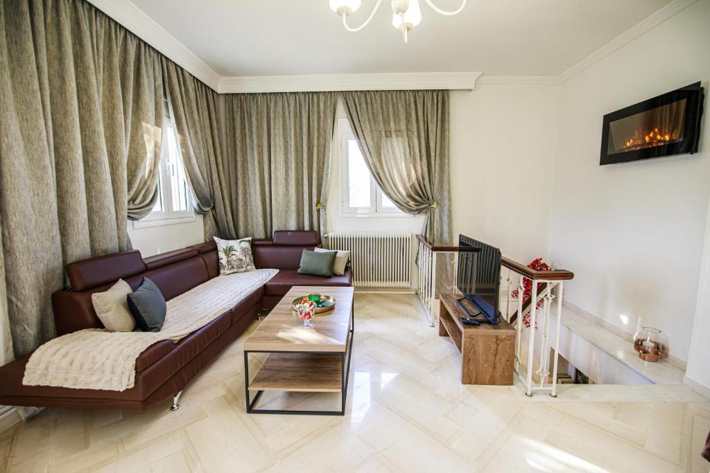 a living room with a couch and a table at Stefania's Home in Ano Volos