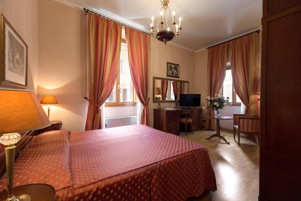 Postel nebo postele na pokoji v ubytování Hotel Bigallo