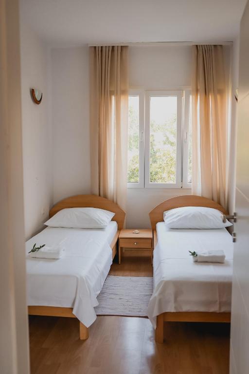 Posteľ alebo postele v izbe v ubytovaní Apartmani Rafaela
