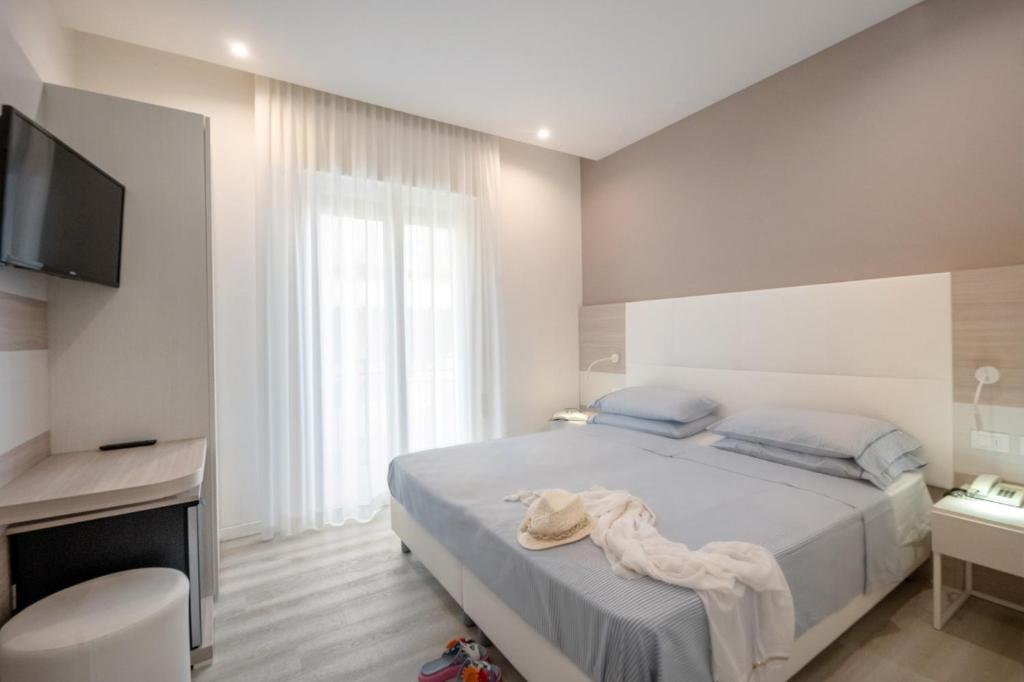 Postel nebo postele na pokoji v ubytování Hotel Miramare