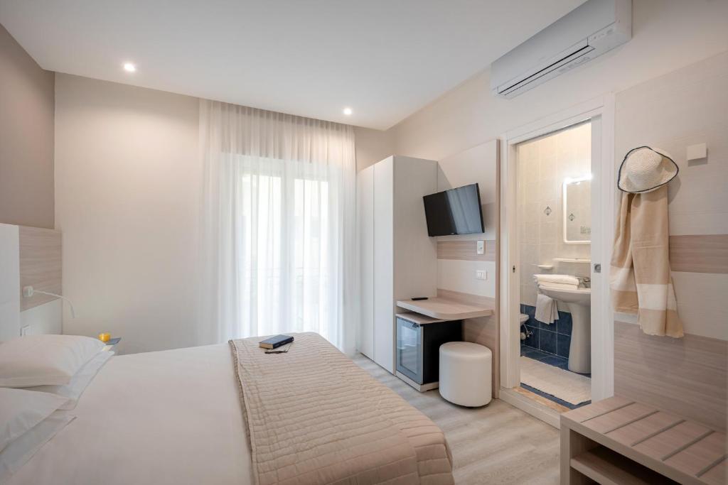 Postel nebo postele na pokoji v ubytování Hotel Miramare