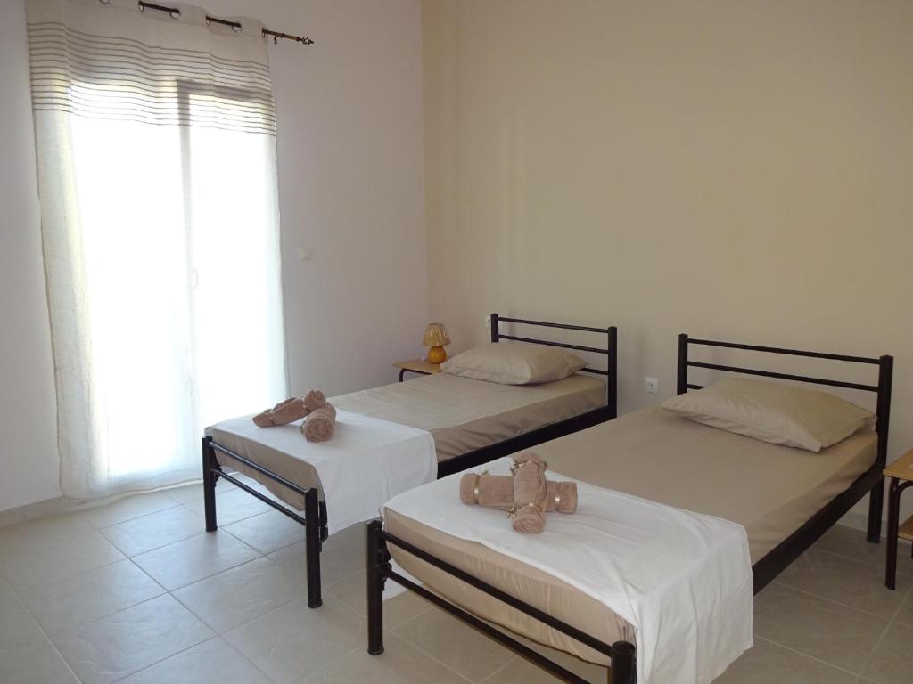 Postel nebo postele na pokoji v ubytování STAMATIS CORFU APARTMENTS