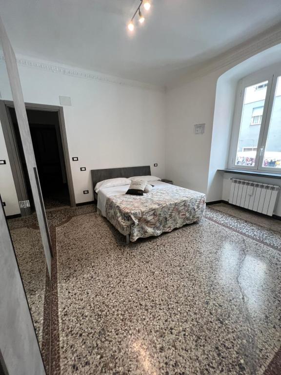 a bedroom with a bed in a white room at Grey house in Genoa