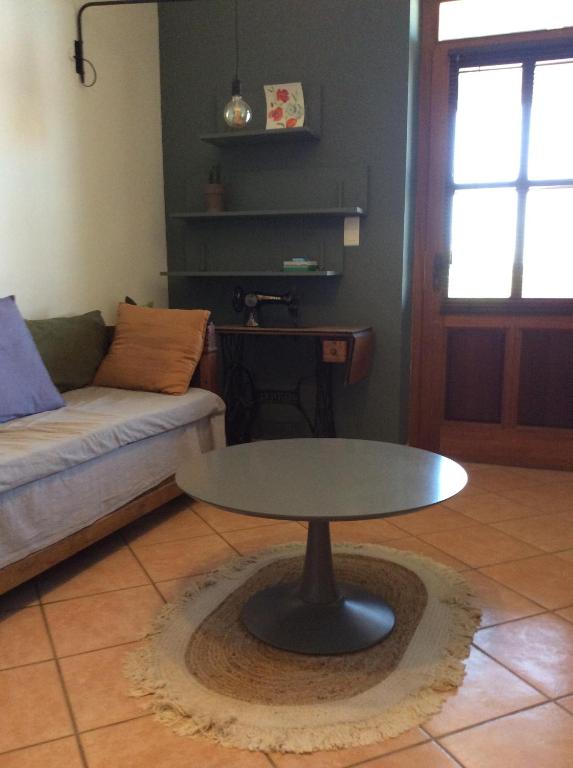 a living room with a table and a couch at La Maison De Stephanie in Porto-Vecchio