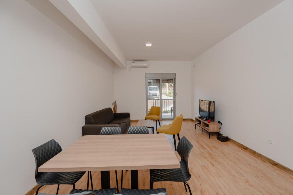 a living room with a table and a couch at Trsteno Beach Apartments in Budva