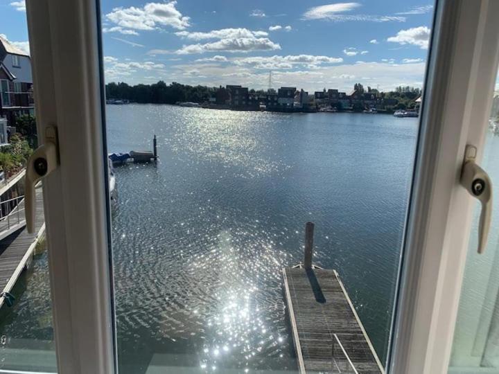 a view of a lake from a window at 4 Bed House with Marina View, Abingdon, Oxford in Culham