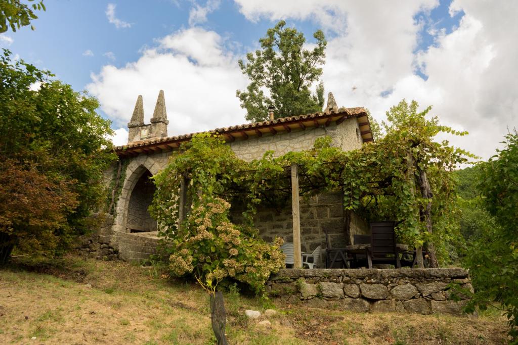 un antiguo edificio de piedra con una mesa delante en Los Prejones, en Arenas de San Pedro