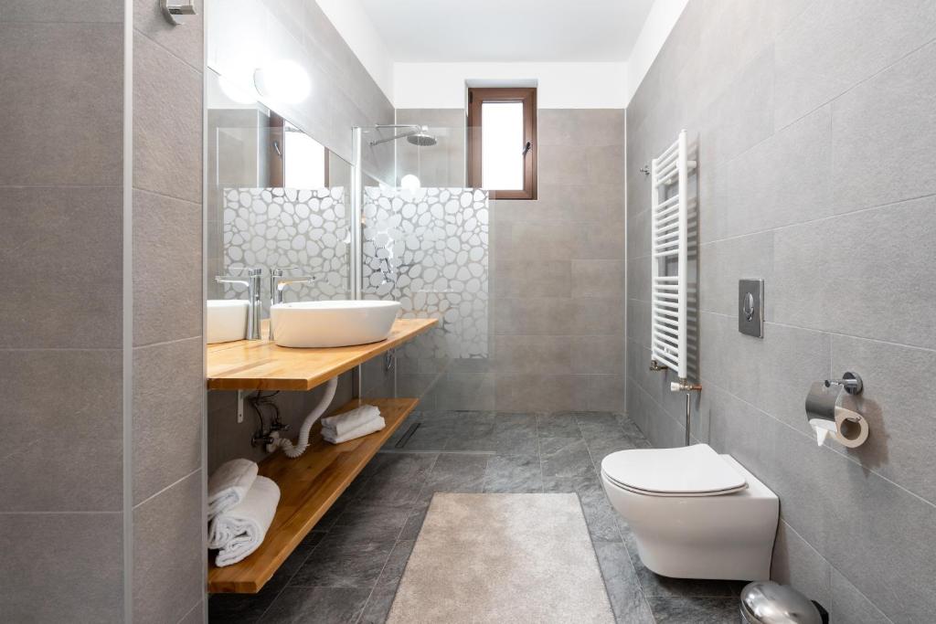 a bathroom with a white toilet and a sink at Nobel Boutique in Bucharest