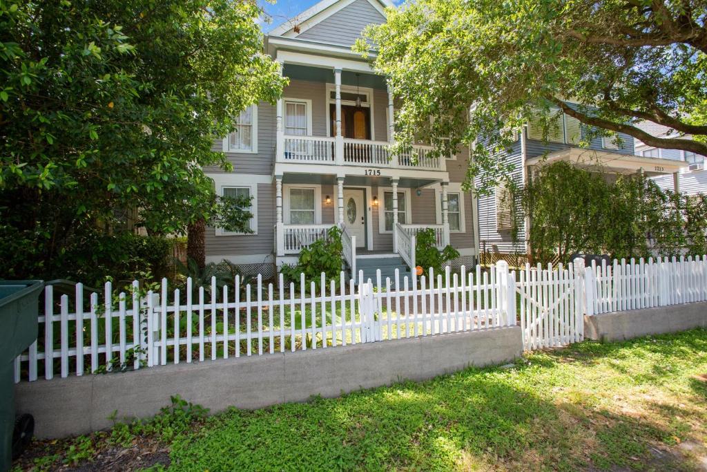 a white picket fence in front of a house at Antigua Key - just a couple blocks to Seawall Beaches, shops, restaurants and Pleasure Pier! home in Galveston