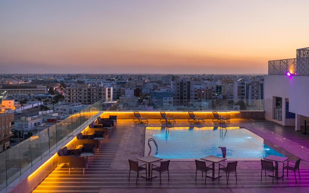 a swimming pool on the roof of a building at Hotel Sfax Palace by Plaza Hotels & Resorts in Sfax