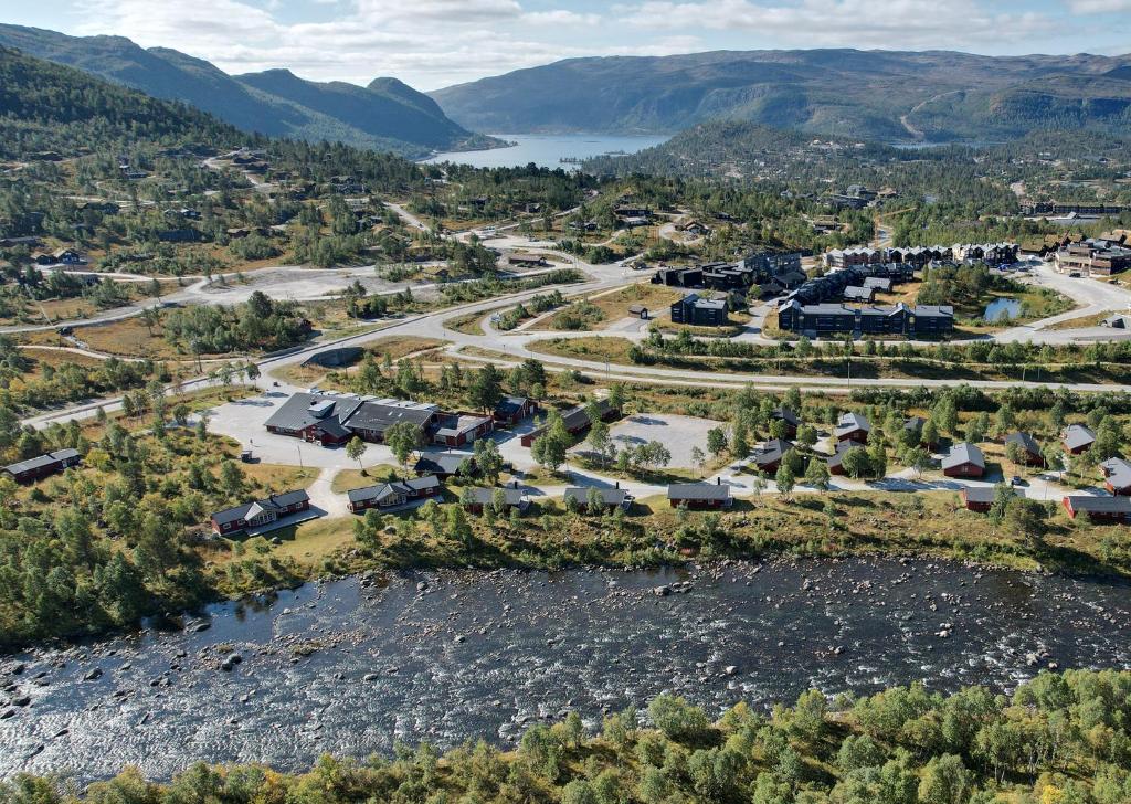 an aerial view of a town with a river and mountains at Hovden Høyfjellsenter in Hovden