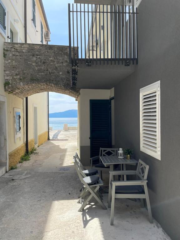 a patio with a table and chairs and the ocean at Ena Diva in Zaostrog