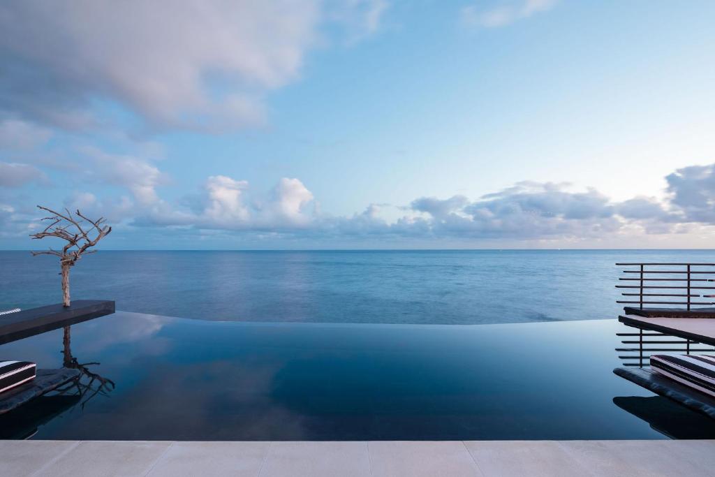a swimming pool with a view of the ocean at White Exclusive Suites & Villas in Lagoa