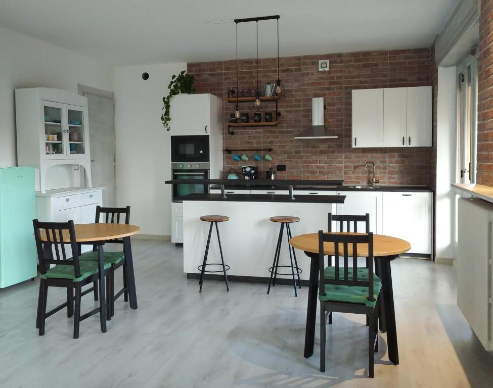 a kitchen with two tables and chairs and a counter at ALLA DAMIGIANA in SantʼAmbrogio di Torino