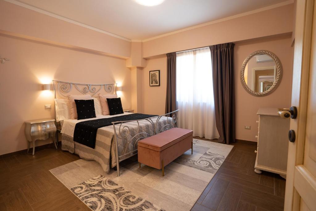 1 dormitorio con 1 cama grande y espejo en Il Castellaccio Bed & Breakfast, en Spello