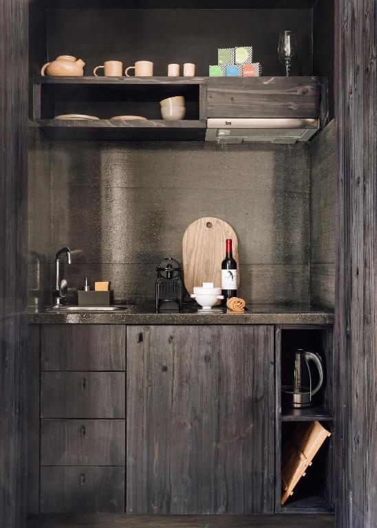a kitchen with a counter with a bottle of wine at White Exclusive Suites & Villas in Lagoa