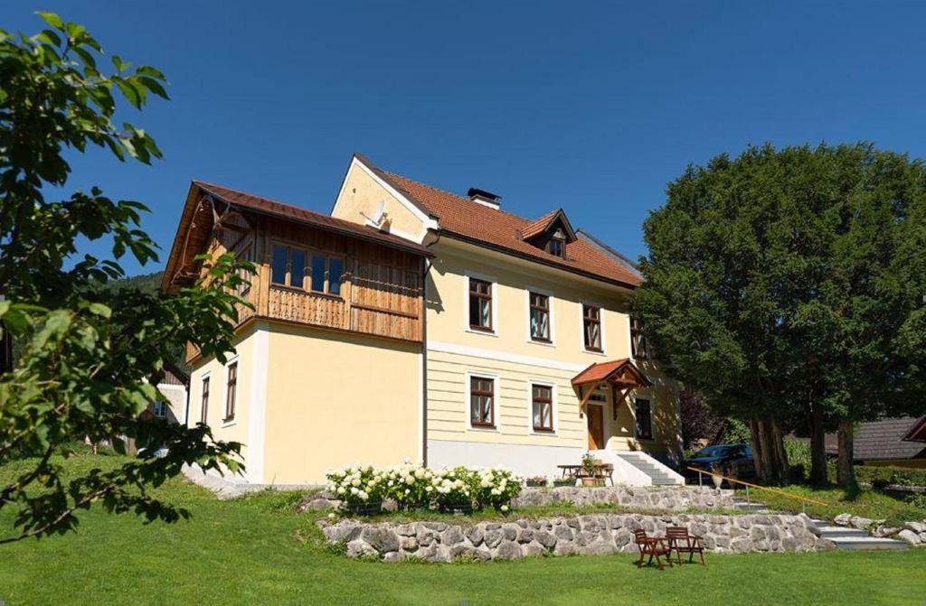 a large white house with a tree in front of it at Apartment Hollenstein in Hollenstein an der Ybbs