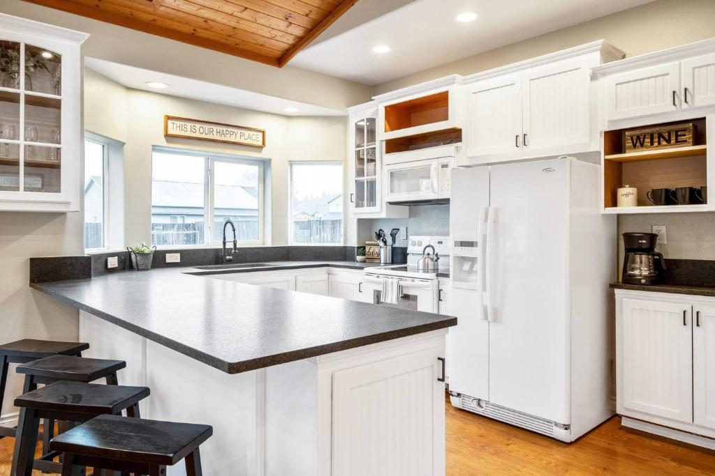 a kitchen with white cabinets and a large island at Dayton Retreat in Dayton