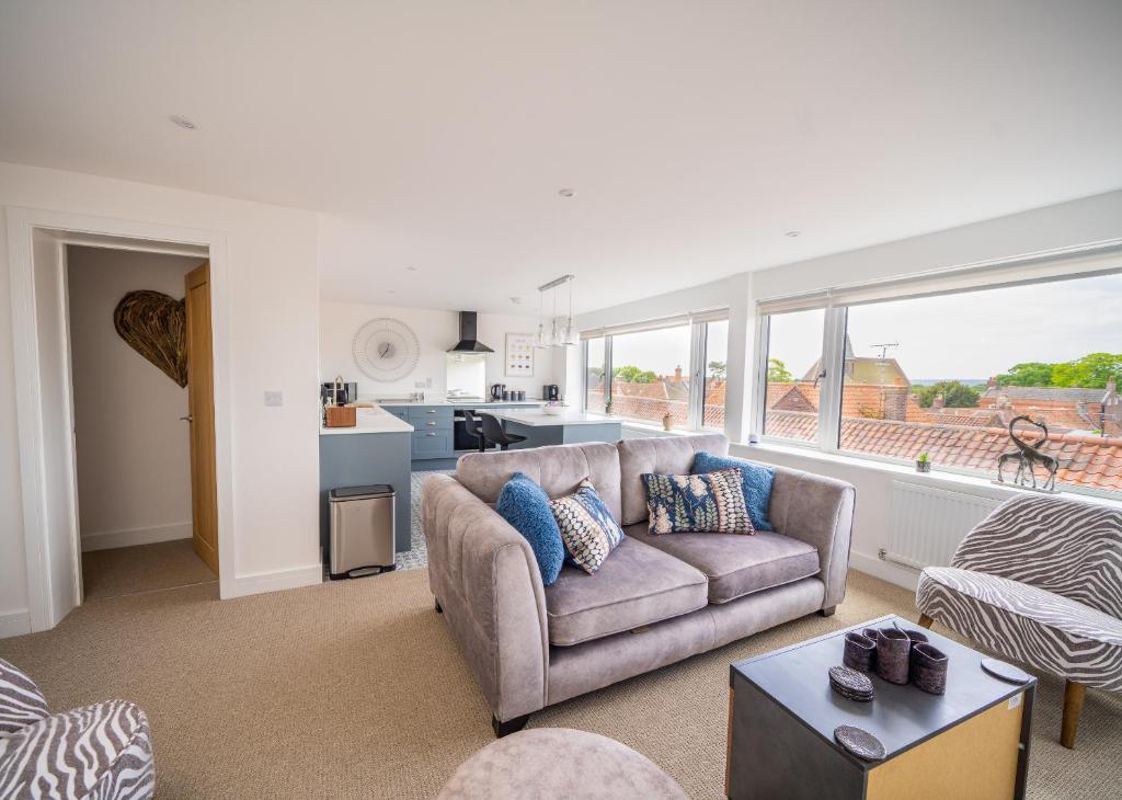 a living room with a couch and a kitchen at 'The View' Penthouse Apartment Number Four Lees Terrace in Holt