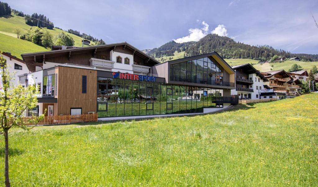 a building in the middle of a green field at Appartementhaus Lackner in Grossarl