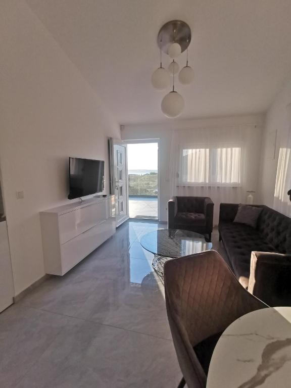 Telewizja i/lub zestaw kina domowego w obiekcie Vrsi Apartments