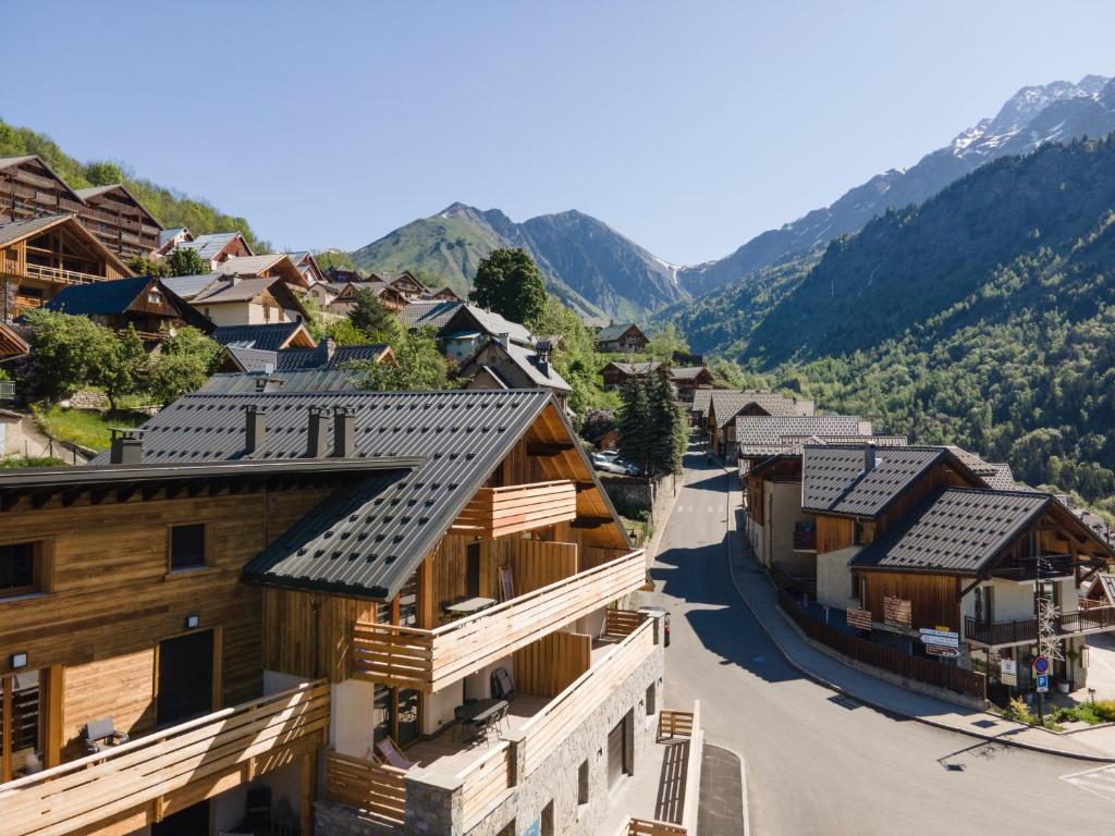 a village in the mountains with wooden houses at TERRESENS - L'ETENDARD in Vaujany