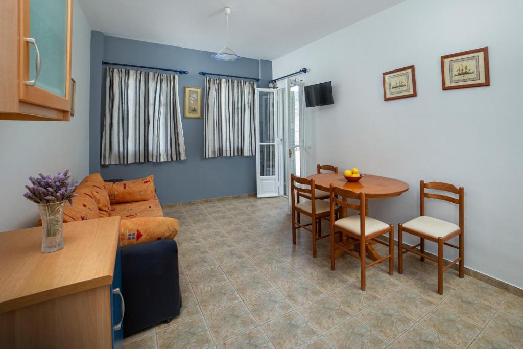 a living room with a couch and a table at Spertos Apartments in Órmos