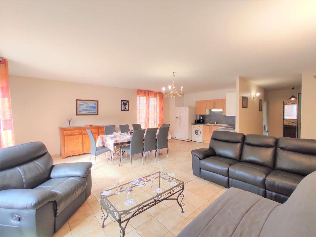 a living room with a couch and a table with chairs at Appartement Saint-Lary-Soulan, 4 pièces, 8 personnes - FR-1-457-182 in Saint-Lary-Soulan