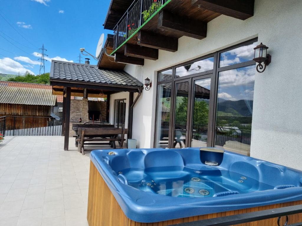 a large blue tub sitting on the outside of a house at Casa Yla in Piatra Neamţ