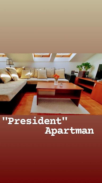 a living room with a couch and a coffee table at Apartman President in Vrnjačka Banja