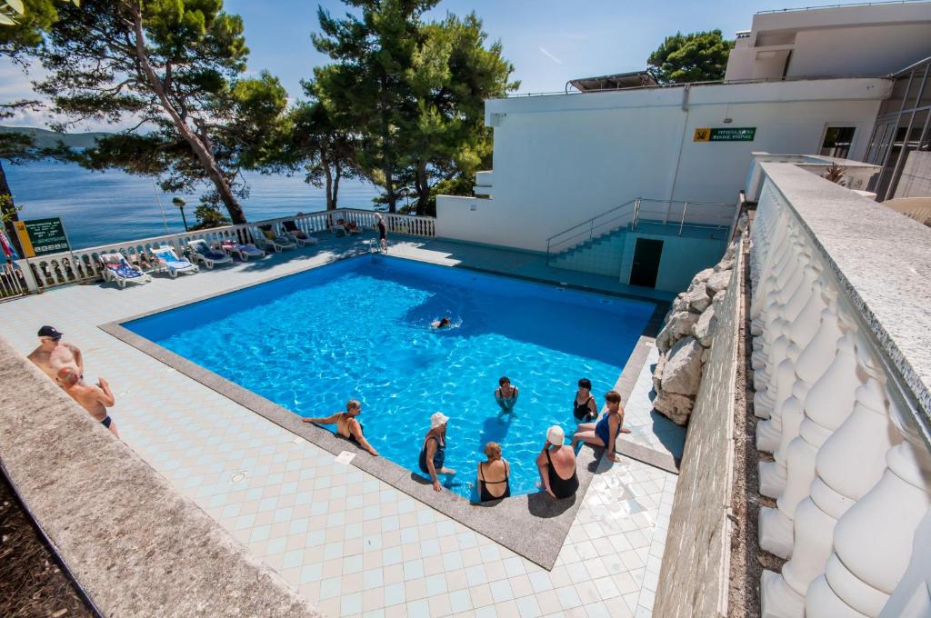 a group of people standing in a swimming pool at Hotel Lavanda in Božava