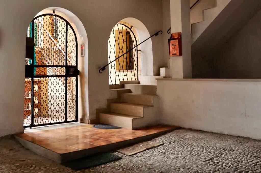 an entrance to a building with a gate and stairs at Baita del me Remo, in the heart of Levico Terme in Levico Terme