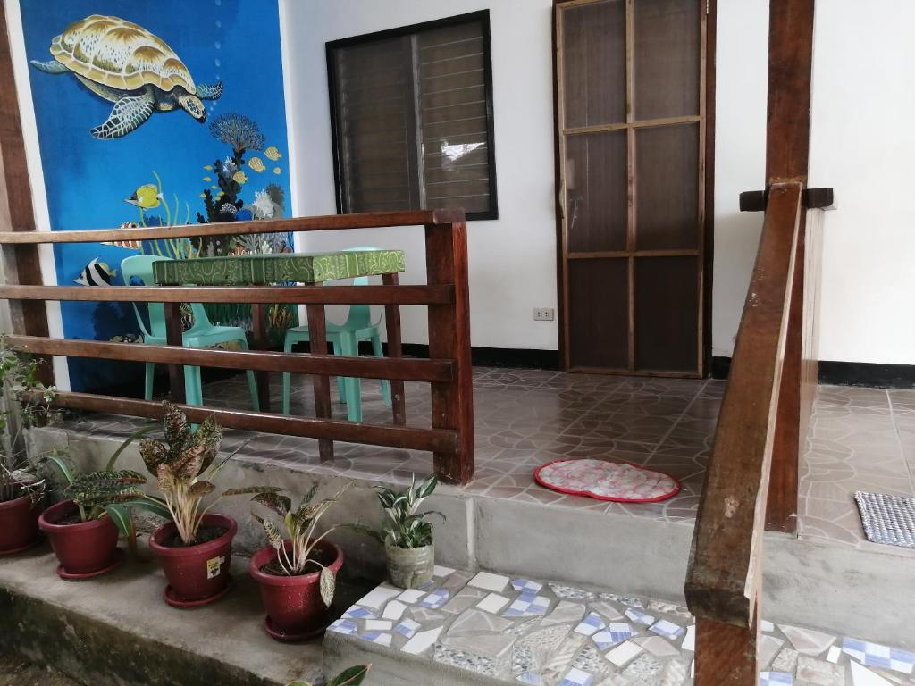 a room with potted plants on the steps at Bundal Riverside Room#1 in Itaytay