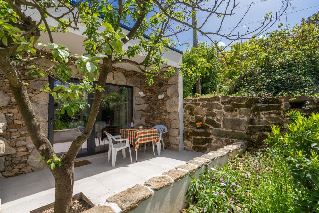 einen Garten mit einem Tisch und Stühlen auf einer Terrasse in der Unterkunft Quinta De Fundevila -quinta privada in Cabeceiras de Basto